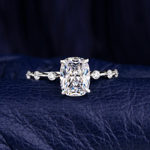 Close‑up photograph of a solitaire diamond set in a metal band, emphasizing the diamond’s sparkle and cut